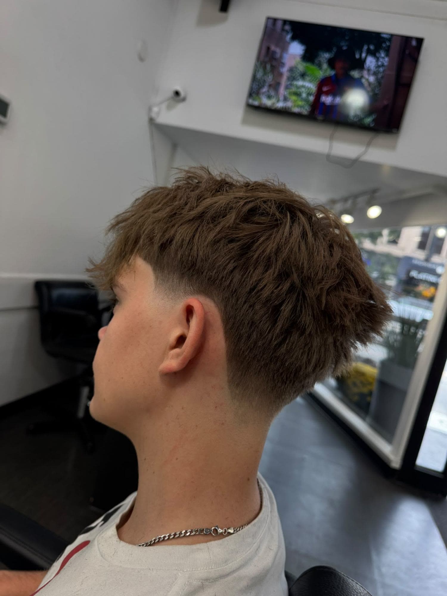 Textured crop with a low taper fade at Glasscut Barbershop