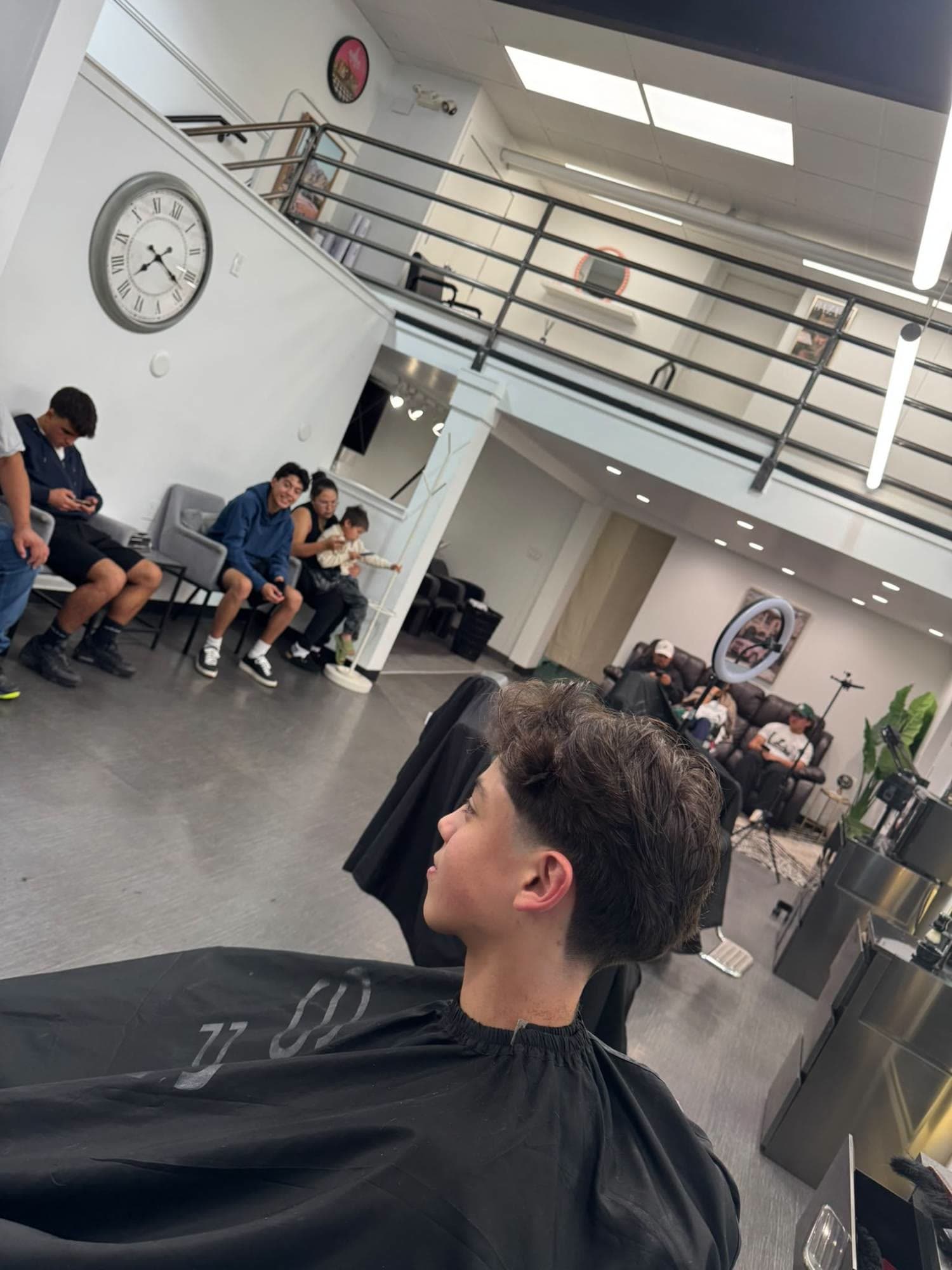 Wavy taper cut, with the Glasscut waiting area and clients behind