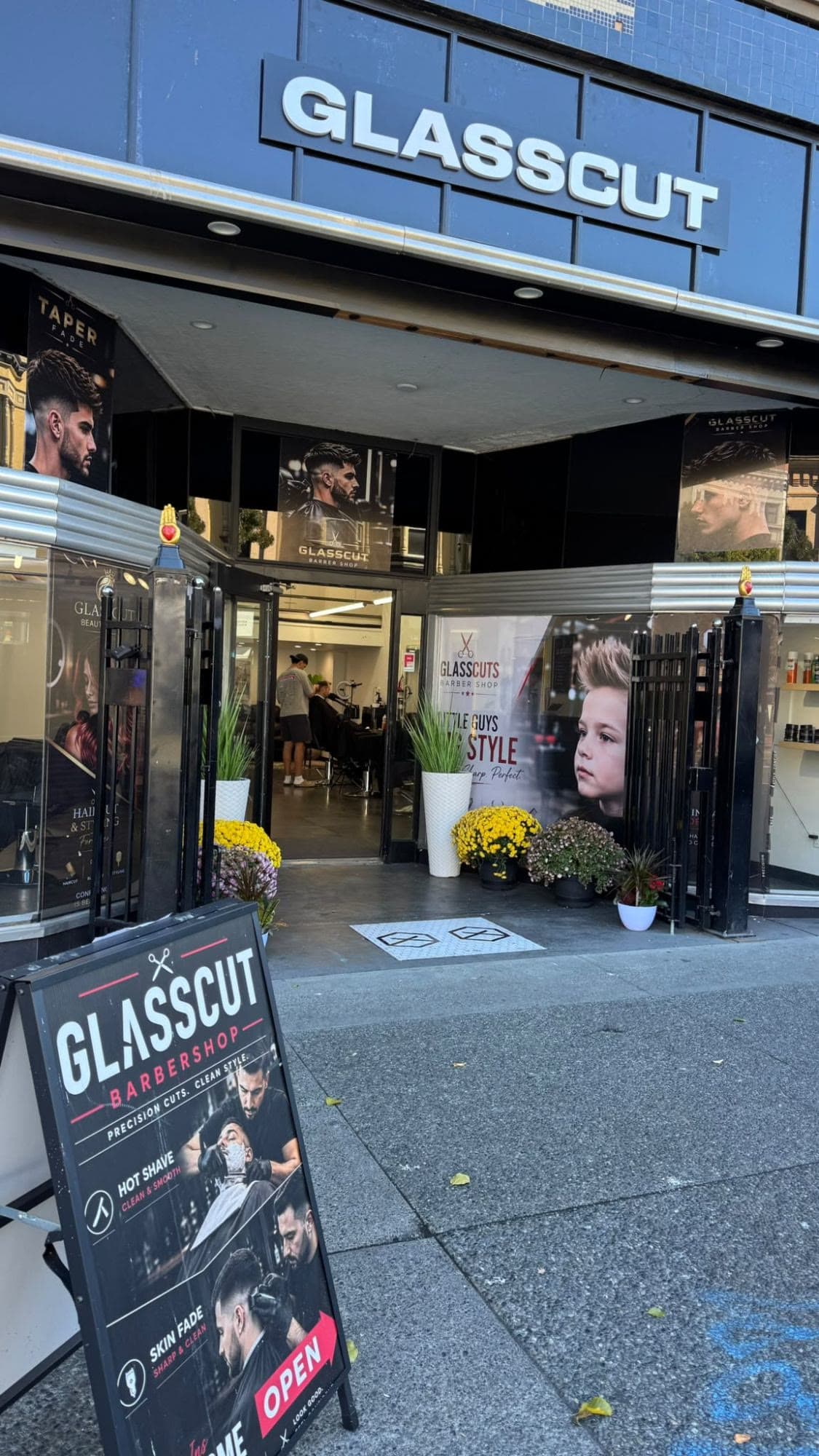 Glasscut Barbershop storefront on Douglas St, Victoria BC — GLASSCUT sign, open entrance, and sidewalk sign