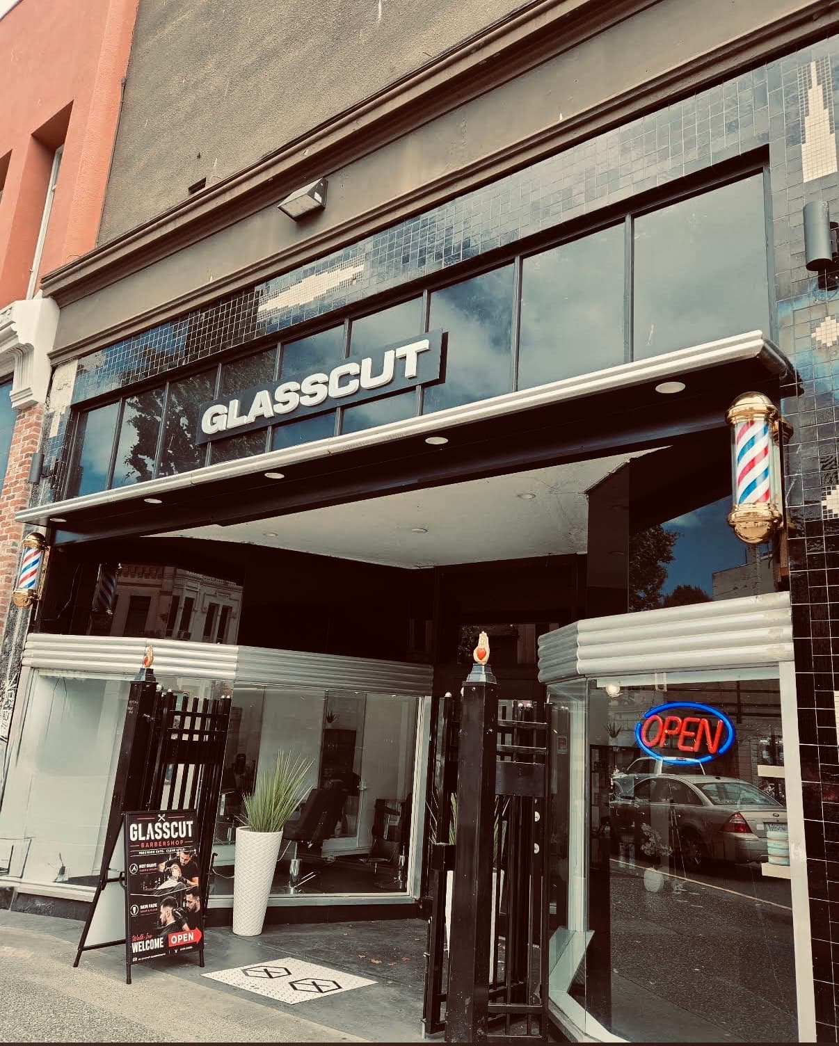 Glasscut Barbershop storefront on Douglas St, Victoria BC — signage, barber pole, and open sign