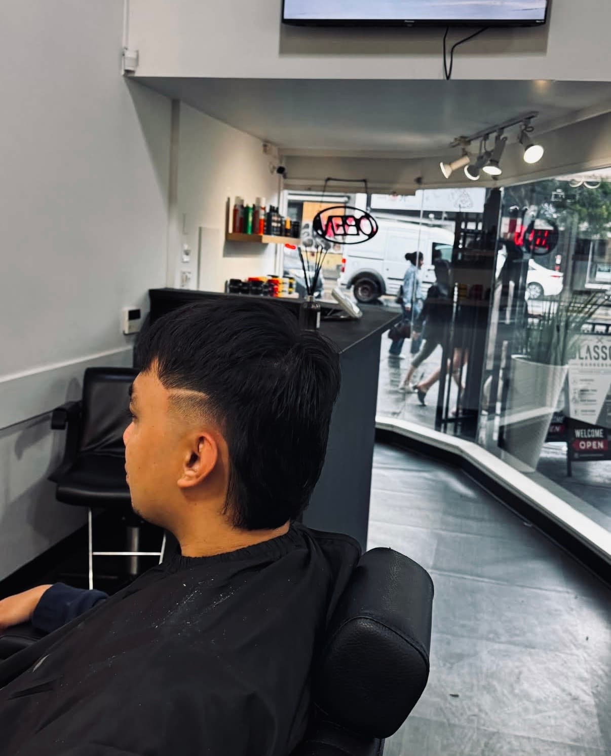 Client getting a haircut at Glasscut Barbershop