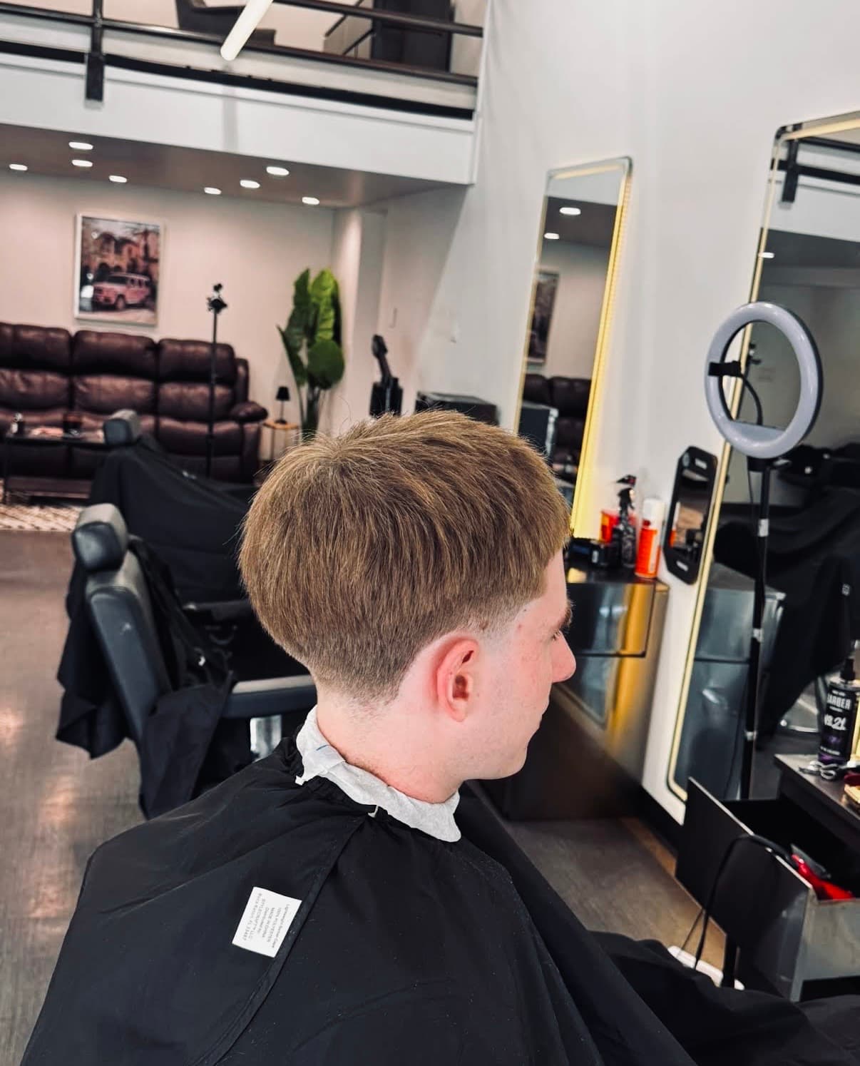 Glasscut Barbershop seating area with mezzanine and ring light