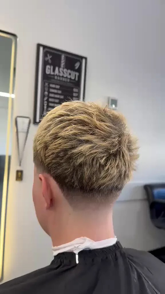 Blond textured cut with a taper fade at Glasscut Barbershop